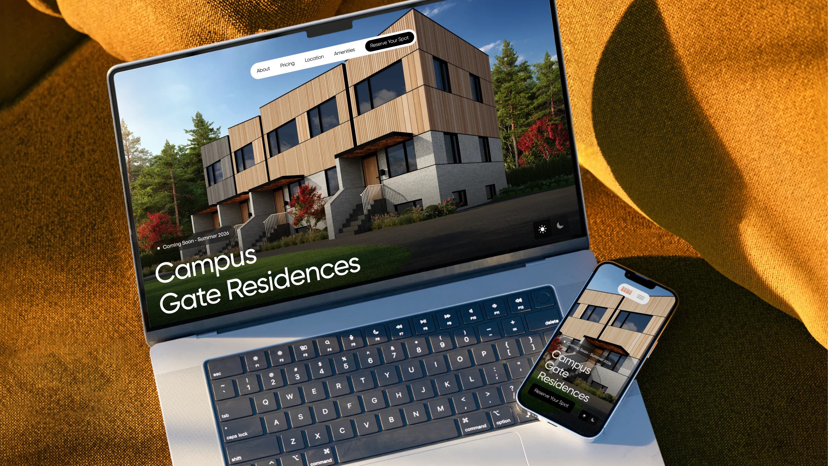 The Campus Gate website open on a laptop and a phone, on a mustard throw: “Campus Gate Residences, coming soon, Summer 2026”